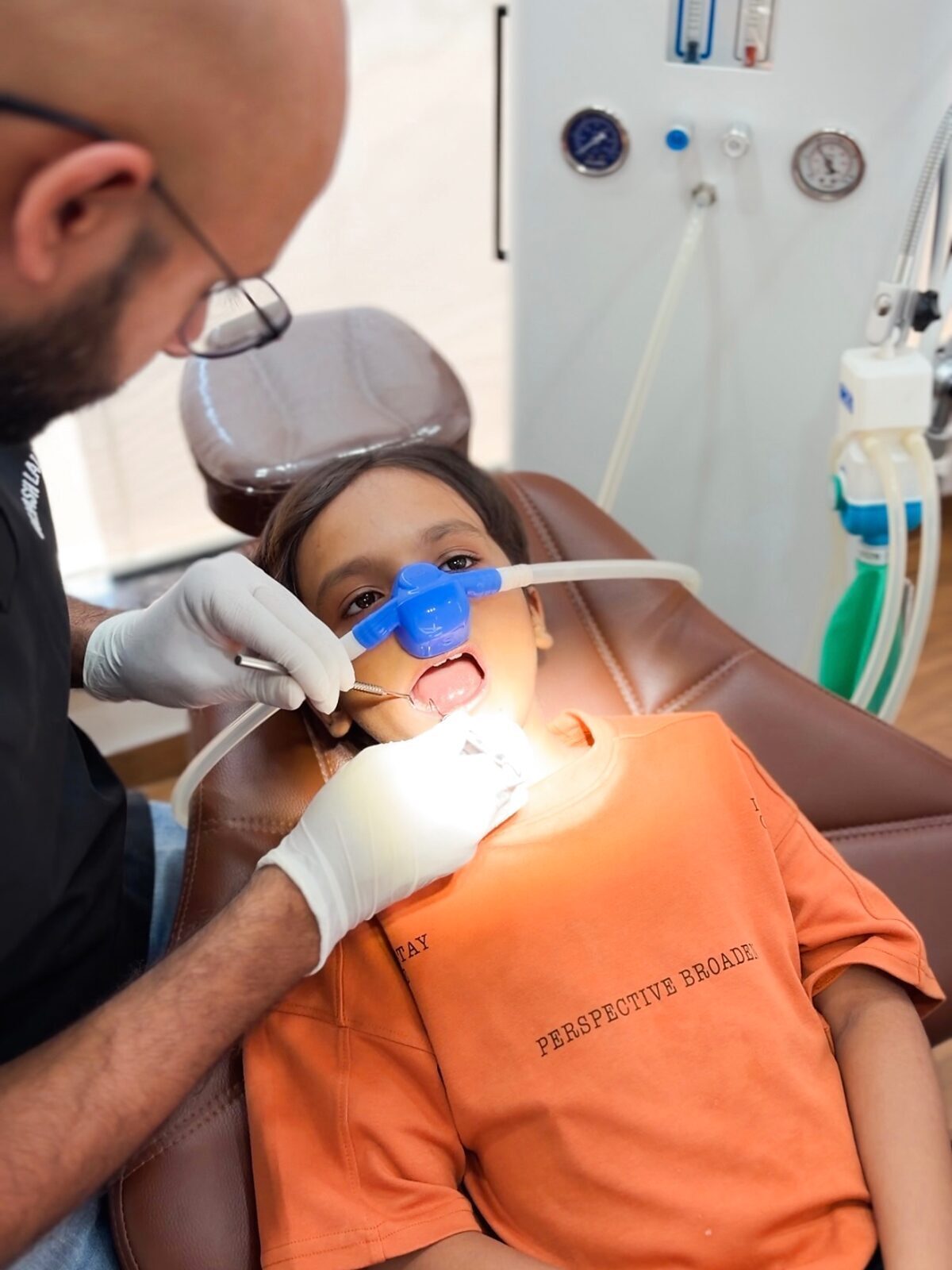 Child receiving laughing gas (Nitrous Oxide-Oxygen) sedation by Dr. Yash Lalwani at Little Angels Kids Dental Care