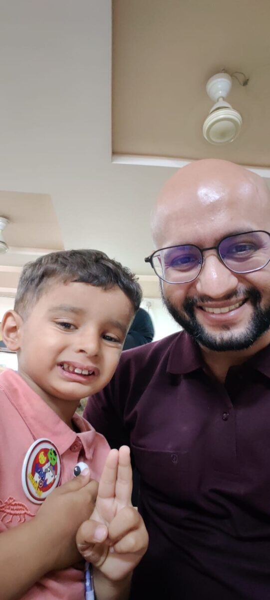 Brave kid showing victory sign with Dr. Yash