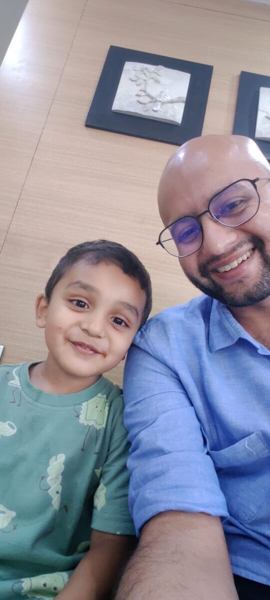 Smiling boy with Dr. Yash at the clinic