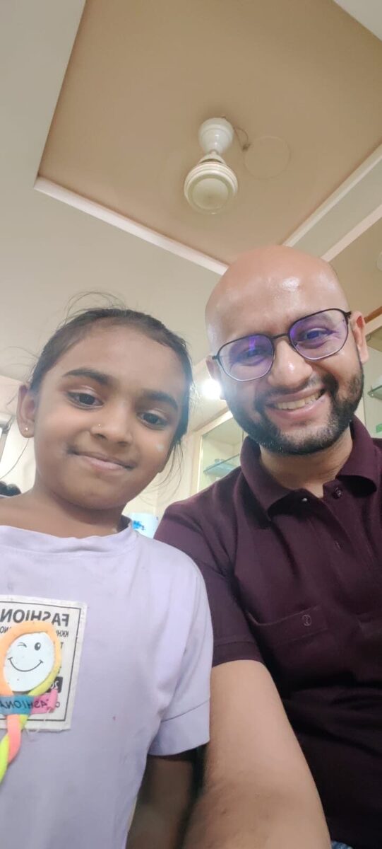 Young girl smiling with Dr. Yash