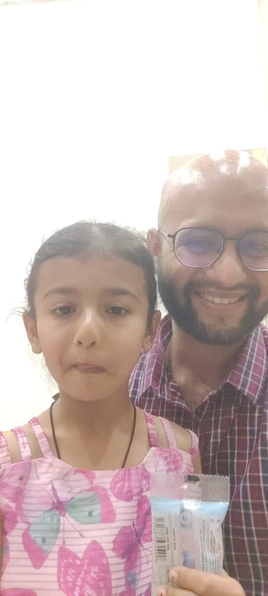 Little patient with Dr. Yash holding a treat