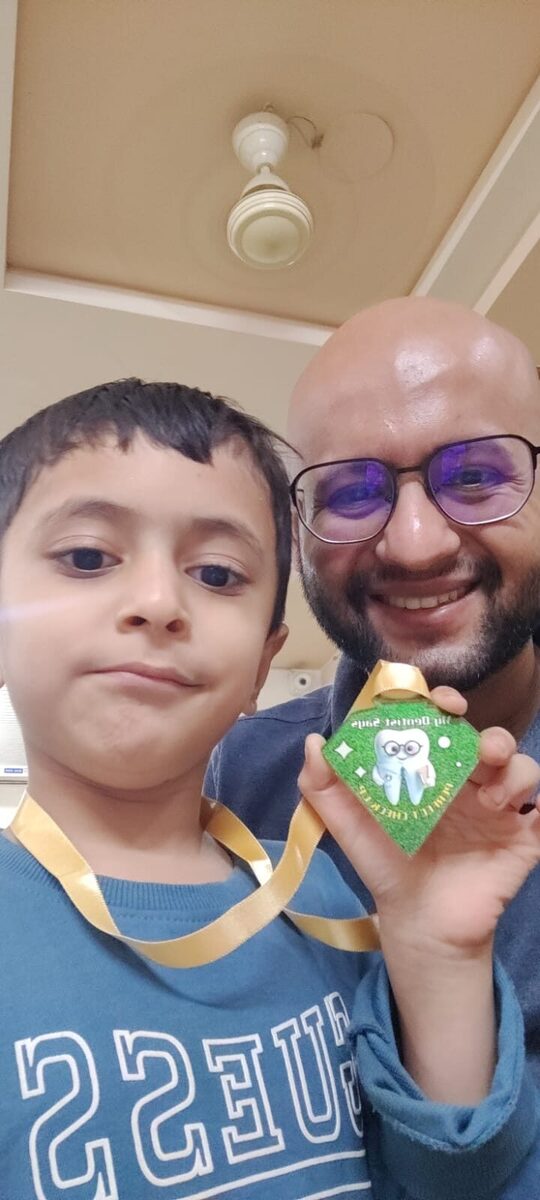 Boy with bravery medal and Dr. Yash